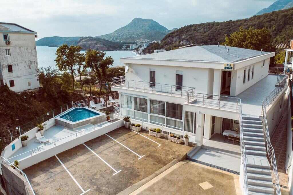 Vila Nikezić seen from above with the pool and the Adriatic behind it